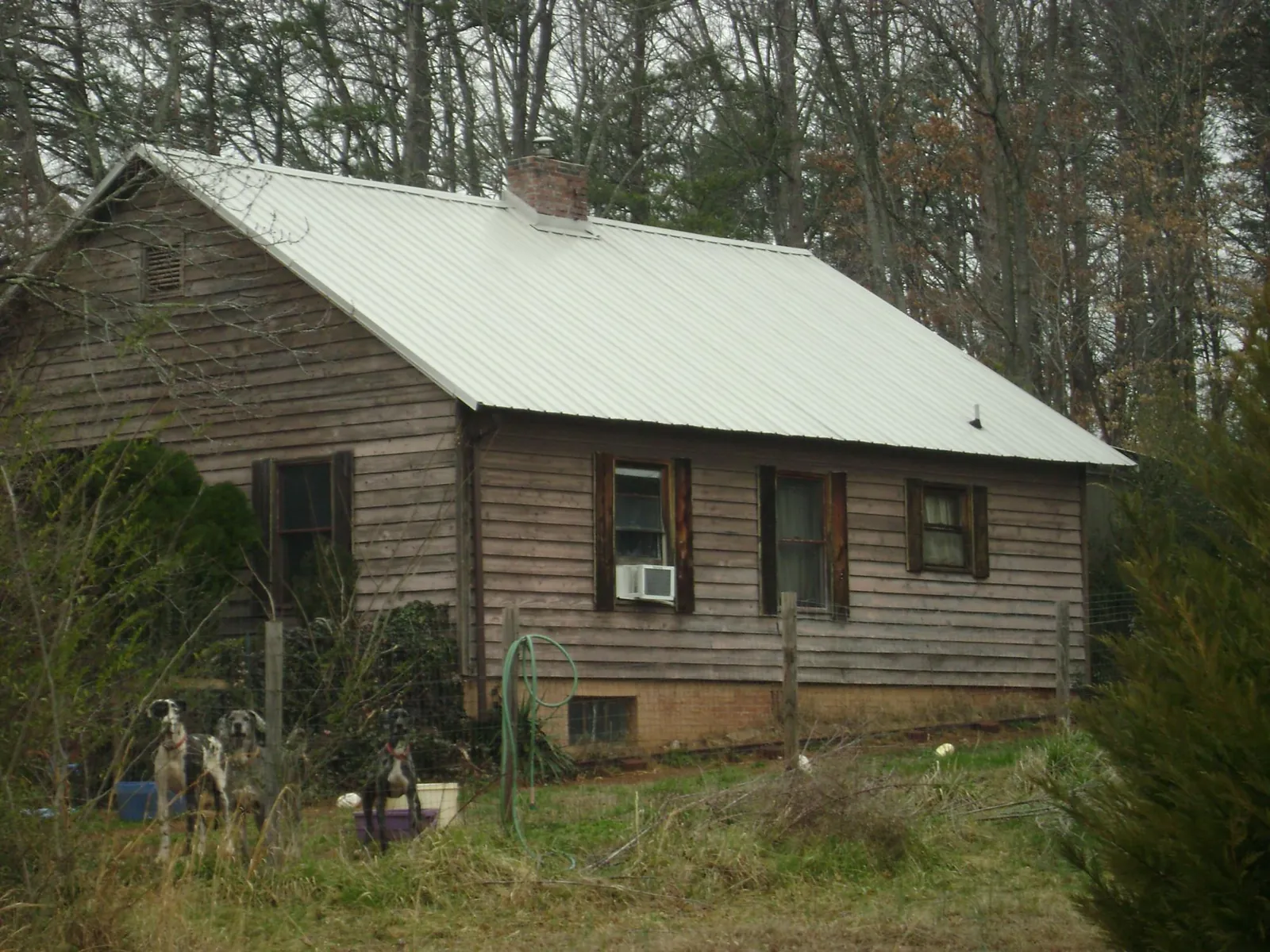 White metal roof on an old wood sided farmhouse, from a Metal Roof Installation job in Willet